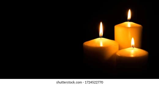 Burning candles in darkness